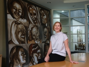 YWCA's Kirsten Sikkelee in front of painting