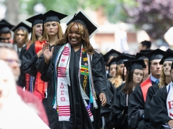Commencement 2025 grad in line waving