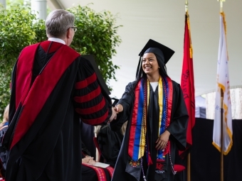 Commencement 2025 student receiving diploma