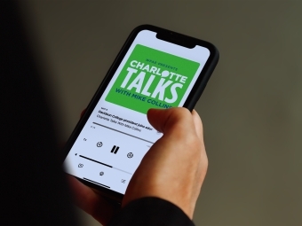 Charlotte Talks podcast playing on phone screen