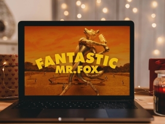 an open laptop with someone watching "Fantastic Mr. Fox"