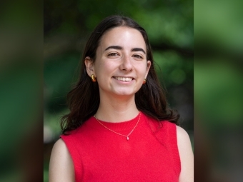 a young white woman with dark hair wearing a red sweater