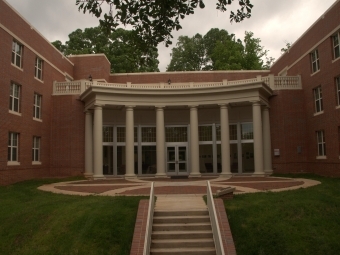exterior of a college building made out of brick and large white columns