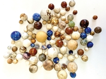 Colorful marbles of all sizes on a white background