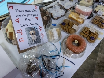 An array of cakes and baked goods with notes from the community