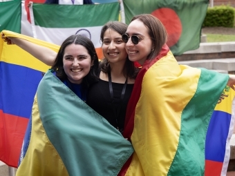 three international students wrapped in flags