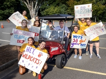 President Hicks surrounded by the move-in crew with posters