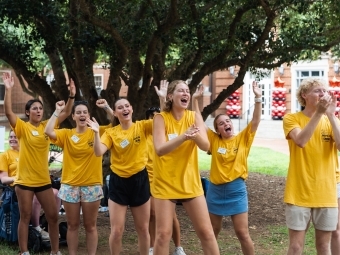 Students in yellow shirts welcome the class of 2029
