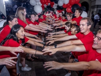 Orientation 2025 Opening Session students join hands to greet the new class of 2029