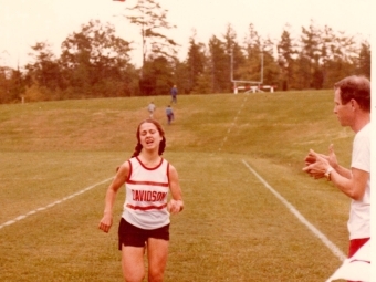 Film photo of Susan Davidson Rollins '76 running through the finish line