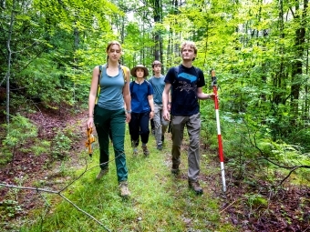 a group of young people hiking in the woods