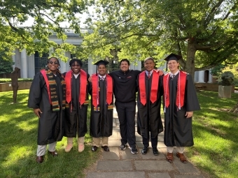 Julian Rawlins ’25 with colleagues at graduation