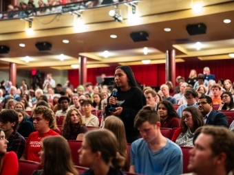 student asking a question during a visit to campus by U.S. Senators Thom Tillis and Amy Klobuchar