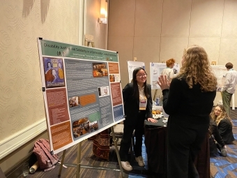 a young woman presents at a conference 