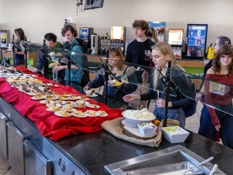 Students swarm the dessert table at Commonsgiving