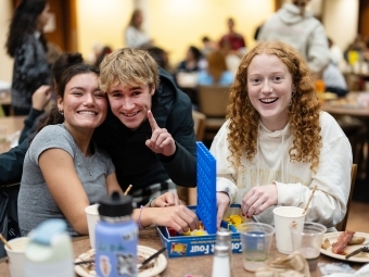 Three students play Connect Four
