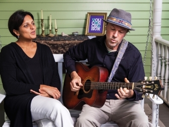 Sethi and her husband, musician Jay Brown, playing guitar on the porch