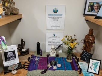 A memorial table with flowers, photos and poems