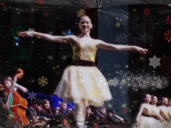2026 Holiday Video Still Ballerina on stage with orchestra to the side