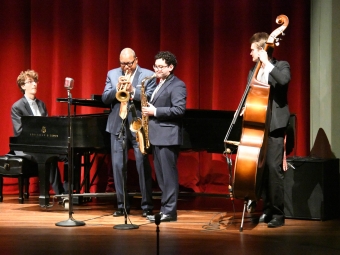 Wynton Marsalis on stage playing music with students during a visit from the renowned American trumpeter and composer
