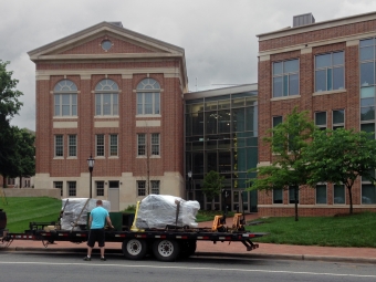 An exterior shot of letterpresses being unloaded in front of Wall