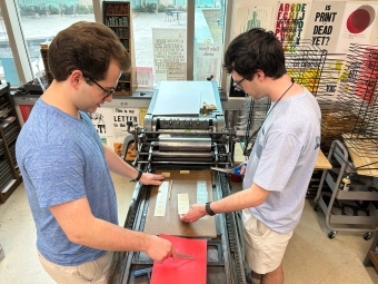 Two male students on press