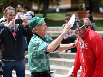 All In for Davidson 2026 someone putting pie on another person's Face