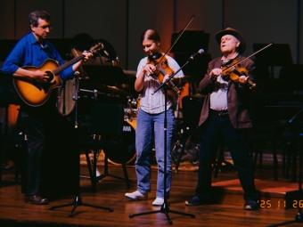 Megan Good ’29 on stage playing the fiddle