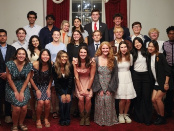 A group of diverse university students in semi-formal attire pose for a multi-row group portrait during a 2026 Student Government Association meeting.