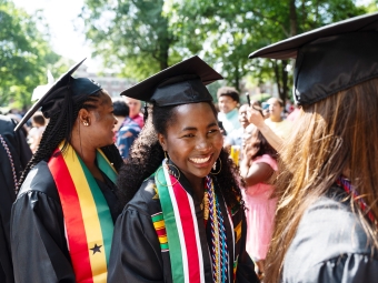 An African American student processing to her seat at commencement