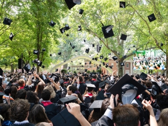 Hundreds of graduation caps are suspended in midair when degrees are announced