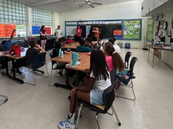 Nora Fenn Gilman ’26 and volunteers in classroom teaching students