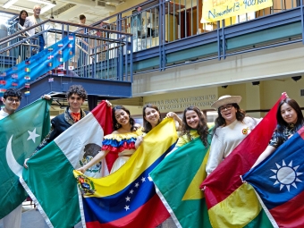 Students hold their flags at the International Association Day Event