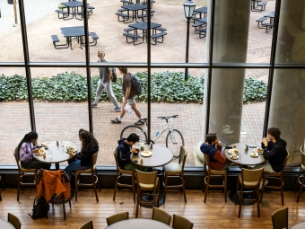 Vail Commons students eat and also walking outside the windows