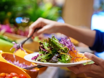 Salad being made at a salad bar (Getty)