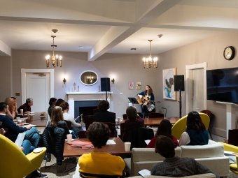 Students and faculty in a room watching a performance of Luis Alfaro’s Electricidad, a reimagining of the ancient Greek Electra 