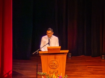 person at the microphone speaking on stage