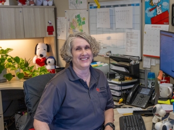 Physical Plant Beth Puckett at her desk 