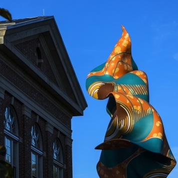 Shonibare Statue in front of Wall Building