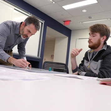 Student and Professor Meet in the Wall Center