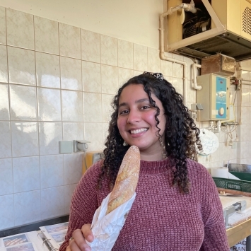 Photo of Marla Ricart '23 holding a baguette