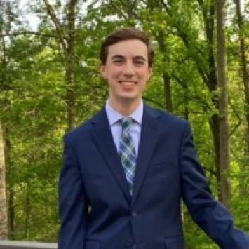 a young white man wearing a suit and tie