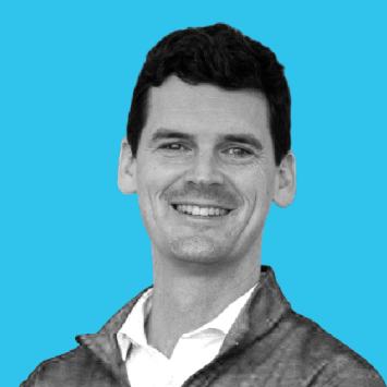 Headshot of a young white man with a collared shirt and dark hair