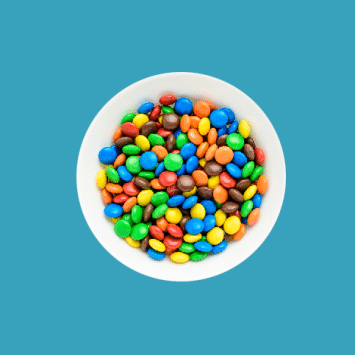 Bowl of M&Ms on a blue background