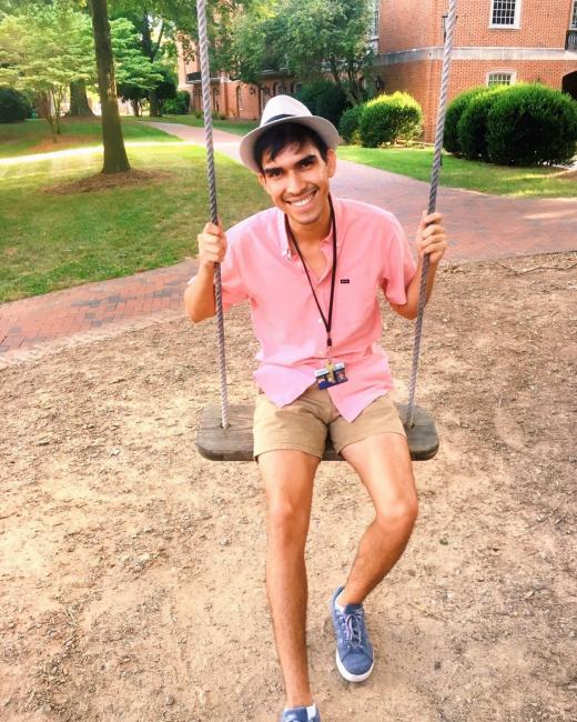 Derian '20 sits on swing for a photo