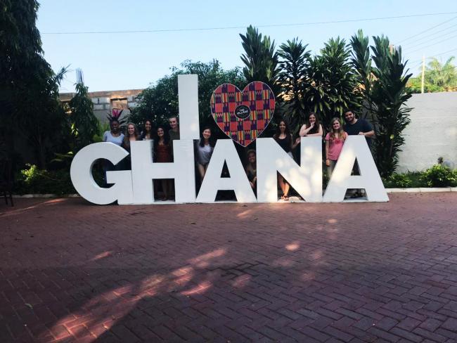 Students in Ghana behind I heart Ghana sculpture