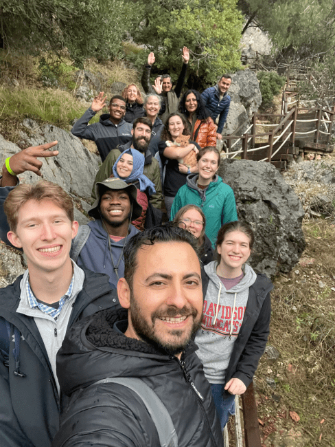 a group of young people take a selfie on the stairs of a mountain
