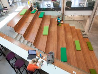 Wall Center wooden amphitheater including students who are studying on the steps 