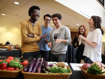 Students in commons with veggies for Cooking with Mamma demonstration