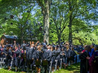 Graduates of the Class of 2019 throw their caps in the air